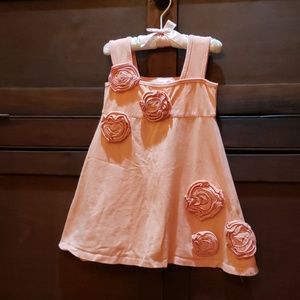 Apricot dress with flower rosettes.